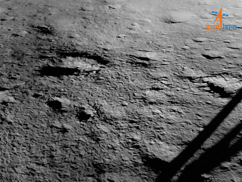 lunar image surface with chandrayaan-3 lander leg in foreground