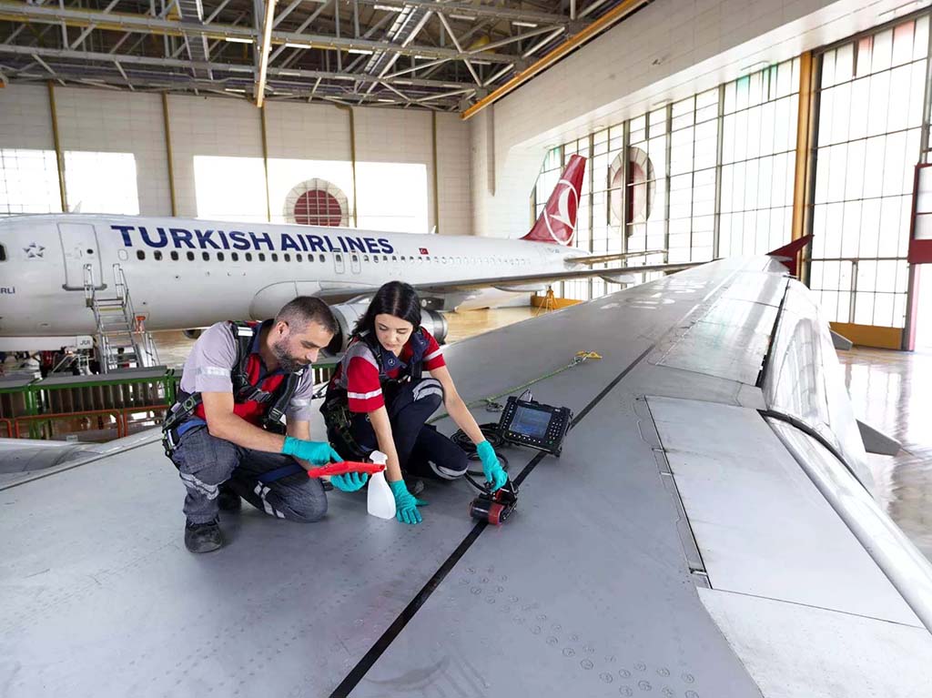 aircraft technicians on wing