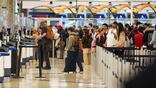 Travelers wait in long lines while only a few TSA check points are open at Hartsfield-Jackson Atlanta International Airport on March 16, 2026.