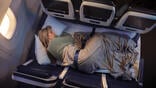 person sleeping on row of three seats