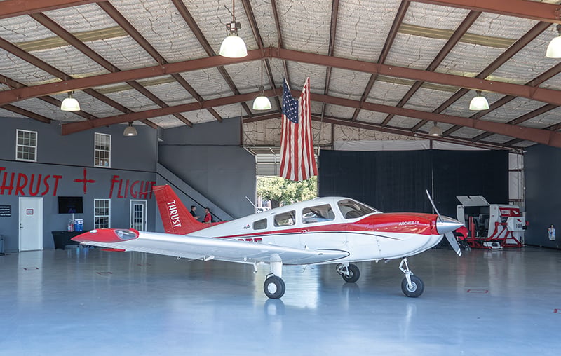 Piper PA-28-181 Archer TX aircraft inside a Thrust Flight hangar