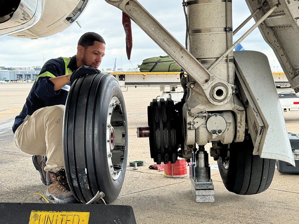 aircraft technician working on landing gear