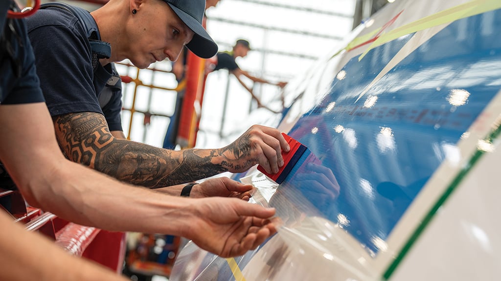 Lufthansa Technik worker applying AeroShark surface treatment