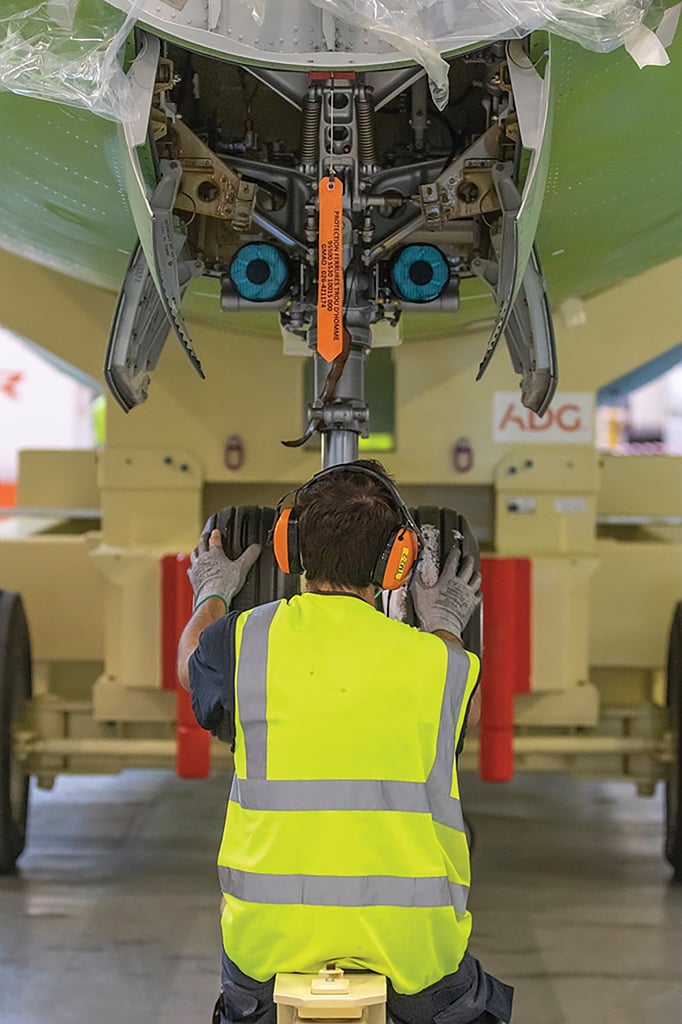 technician under an aircraft