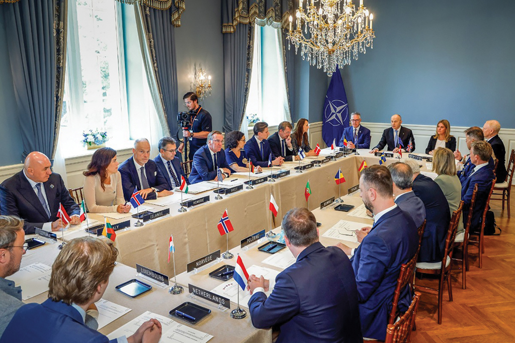 NATO officials sitting around long table