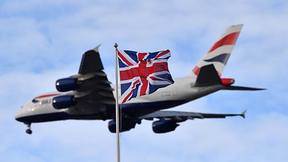 aircraft flying above British flag
