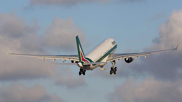 alitalia aircraft taking off into clouds