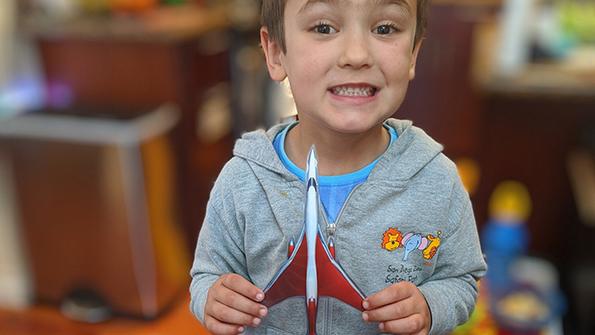 child holding fighter plane cutout