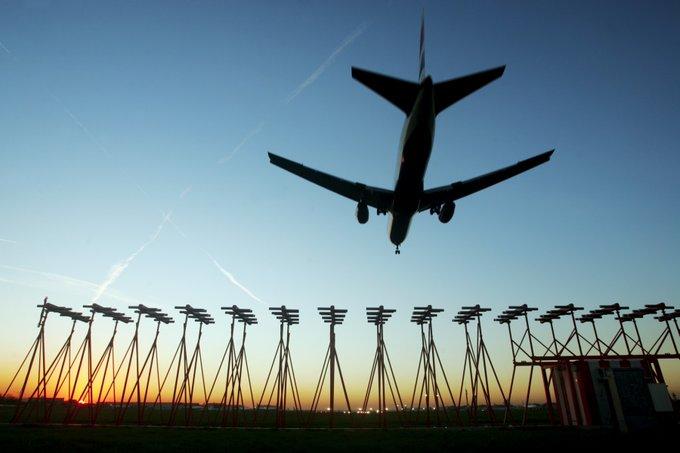 Plane flying above Heathrow Airport