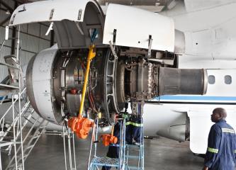 airline mechanics inspecting engine