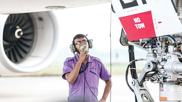 srilankan airlines maintenance technician looking at aircraft