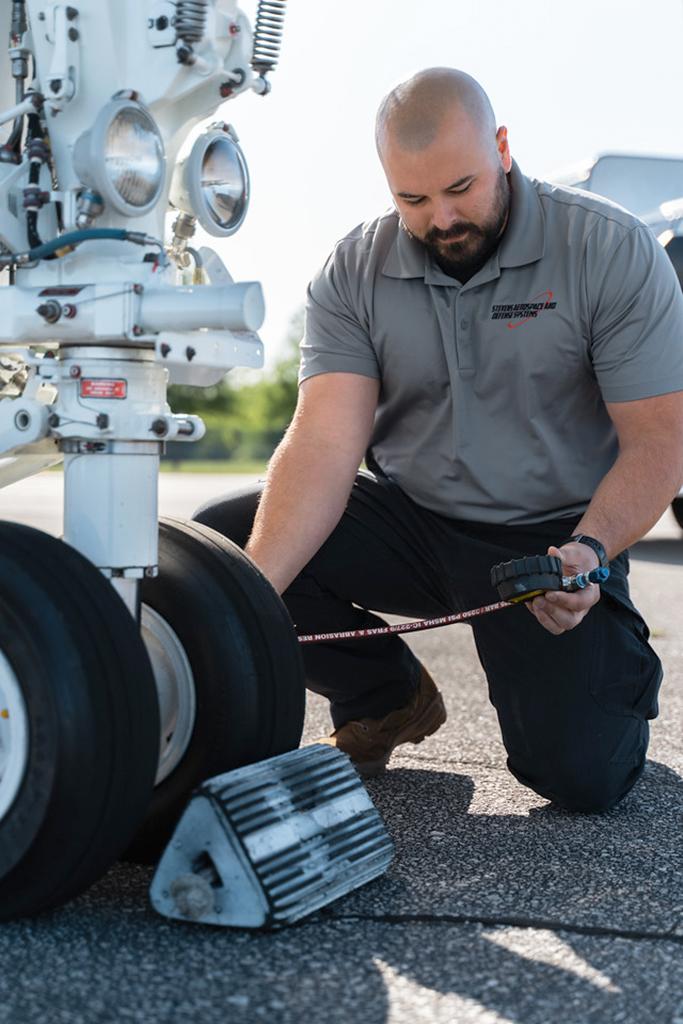 Stevens Aerospace technician David Dumas inspecting a Challenger aircraft