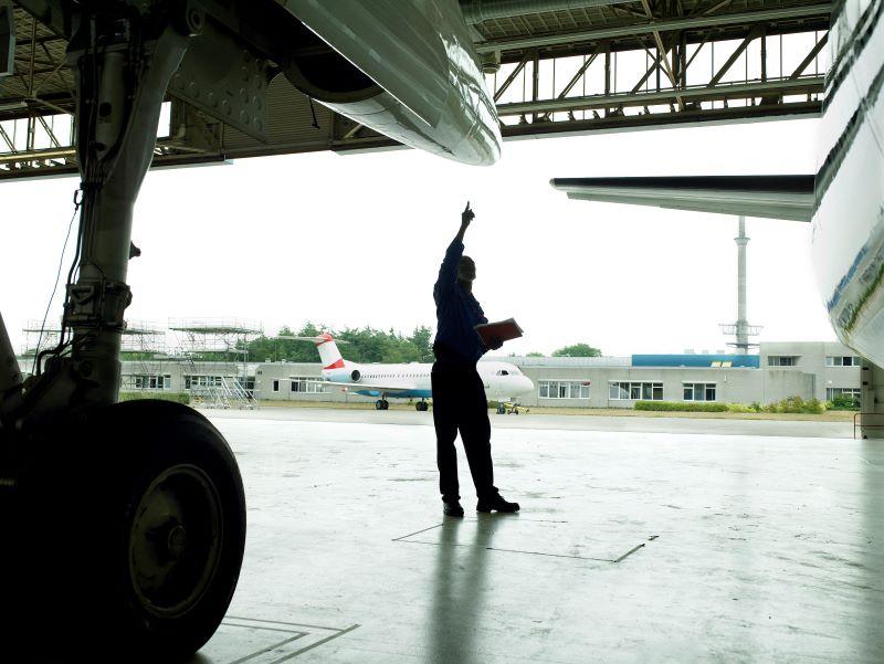 hangar with employee and aircraft