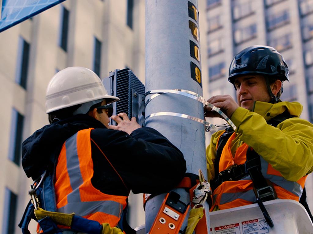 AT&T technicians install a 5G antenna system