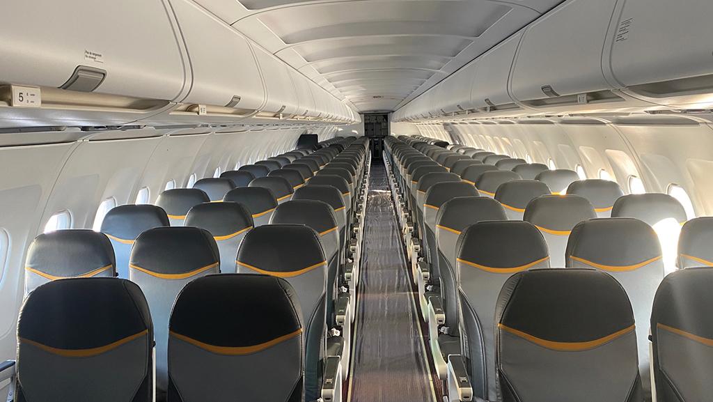 Aircraft cabin showing additional rows of new, slimmer seats