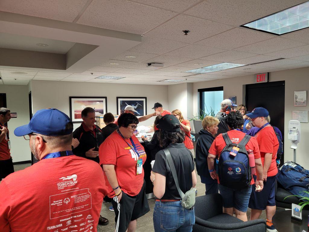Kansas athletes wait to board aircraft in Wichita on June 4.