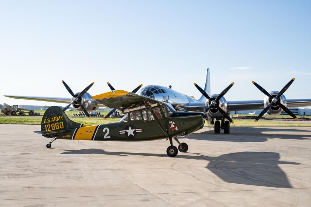 Cessna L-19 Bird Dog taxis past B-29 Doc