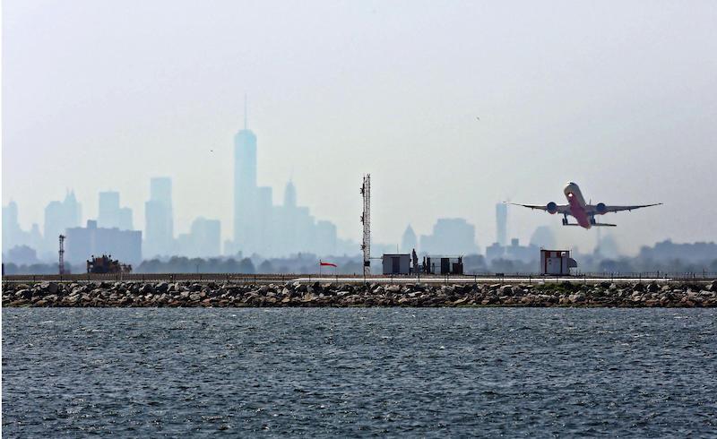 plane takes off from JFK New York skyline