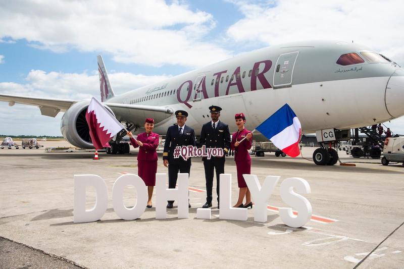 qatar airways staff in front of plane
