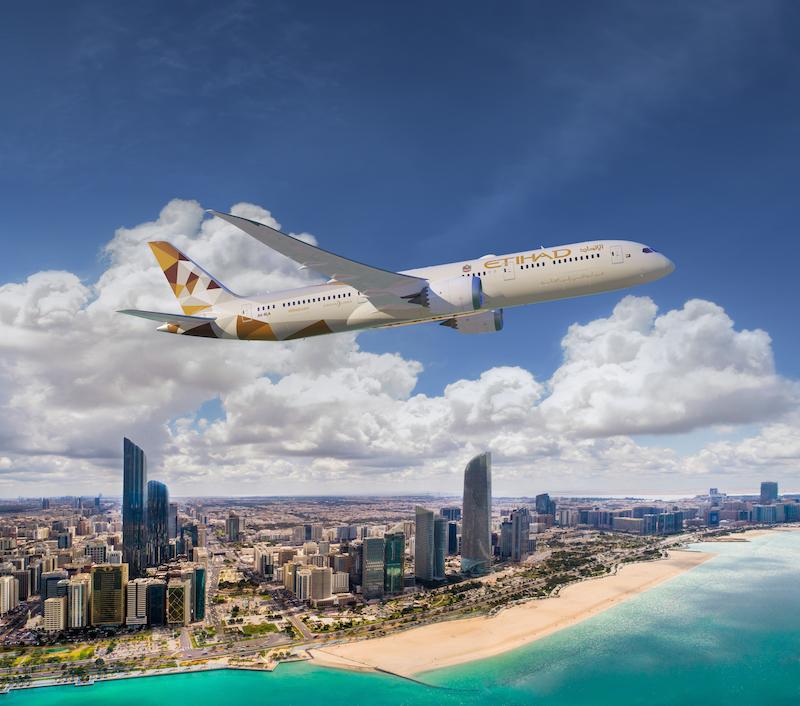 etihad airways jet over Abu Dhabi skyline