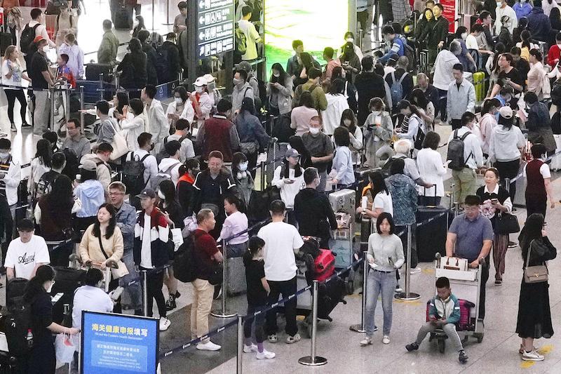 A Beijing Capital International Airport departure lobby is crowded with people flying out of the Chinese capital on Sept. 29, 2023