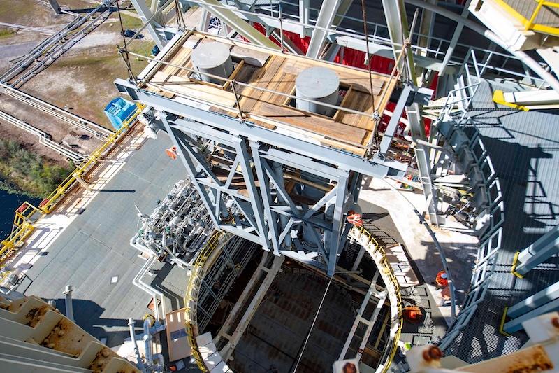 Teams at Stennis installing large diffusers onto a test stand