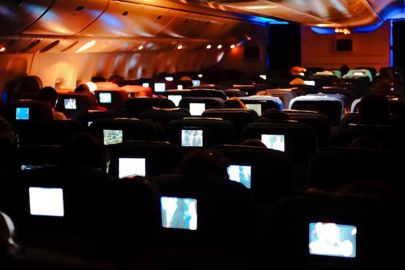 inflight entertainment systems on plane at night