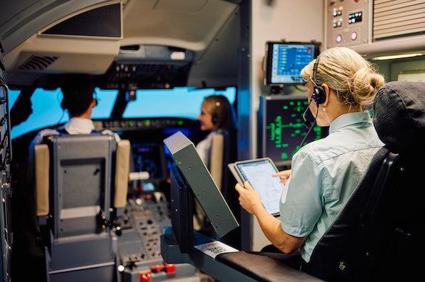 student pilots in flight simulator