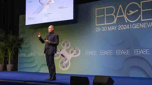 Bertrand Piccard giving the keynote address on stage at EBACE 2024