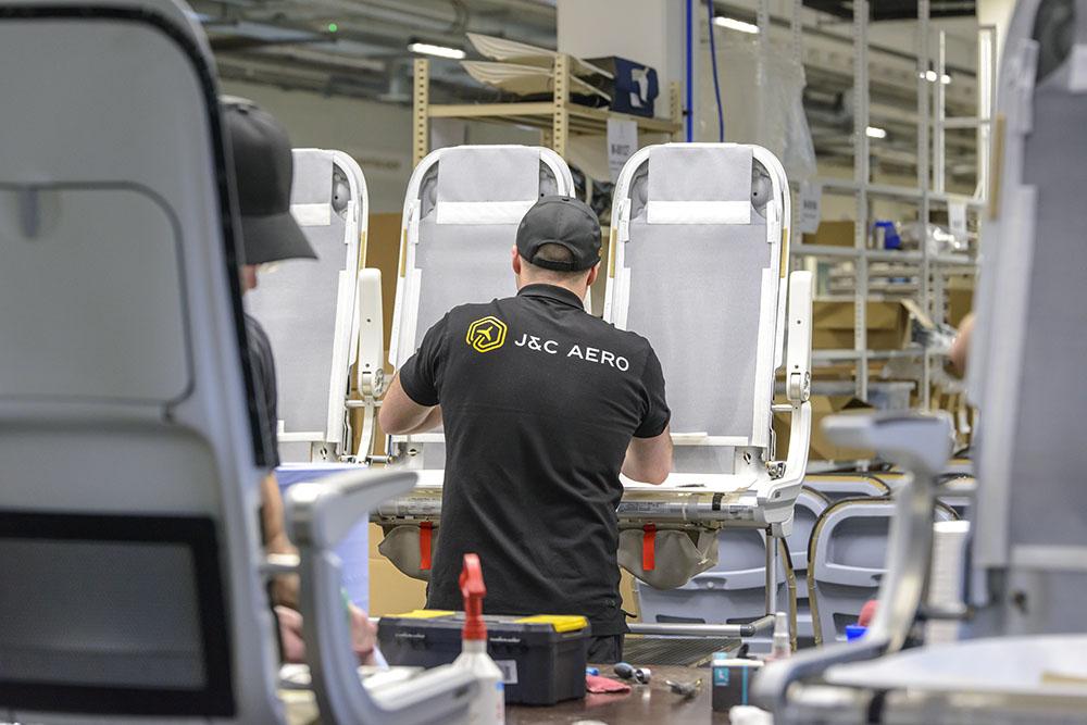 Technician working on aircraft seats