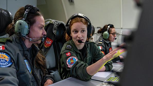 Canadian NATO AWACS service member (left) talking with Danish service member