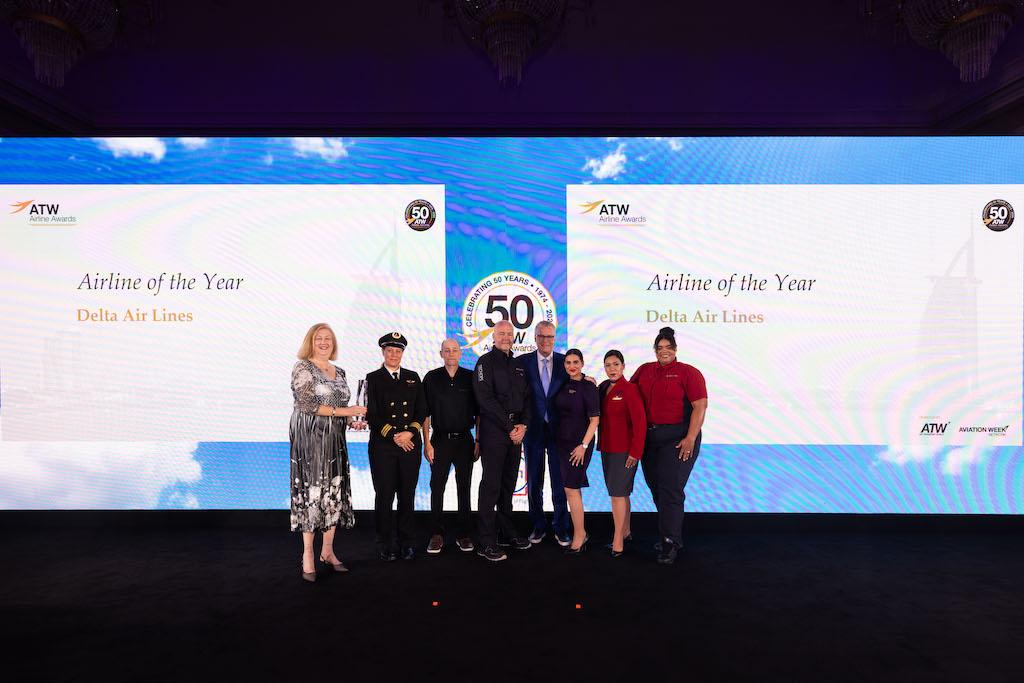 Delta CEO Ed Bastian alongside a group of Delta frontline workers.