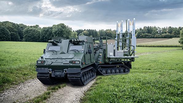 Diehl armored vehicle transporting missiles on grassy field
