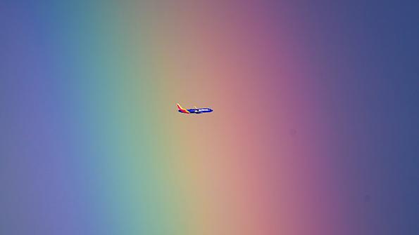 Southwest Airlines aircraft flying through rainbow