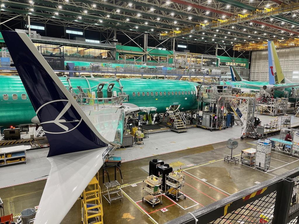 A Boeing 737 being constructed in an airplane hangar.