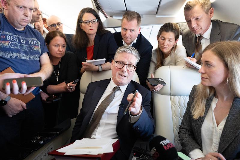 keir starmer on plane talking to journalists