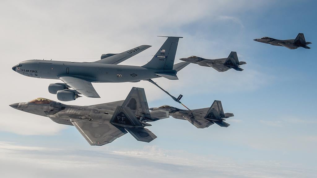 F-22 fighters and KC-135 tankers in flight