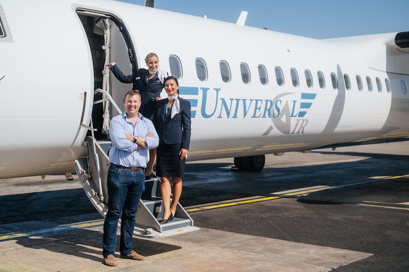 simon cook in front of universal air plane on tarmac