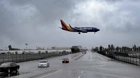 Southwest aircraft flies over a flooded road