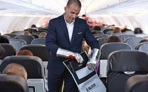 flight attendant using fire containment bag