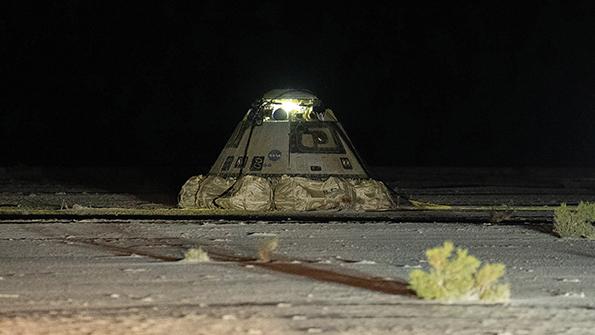 boeing cst-100 starliner calypso on ground in desert at night 