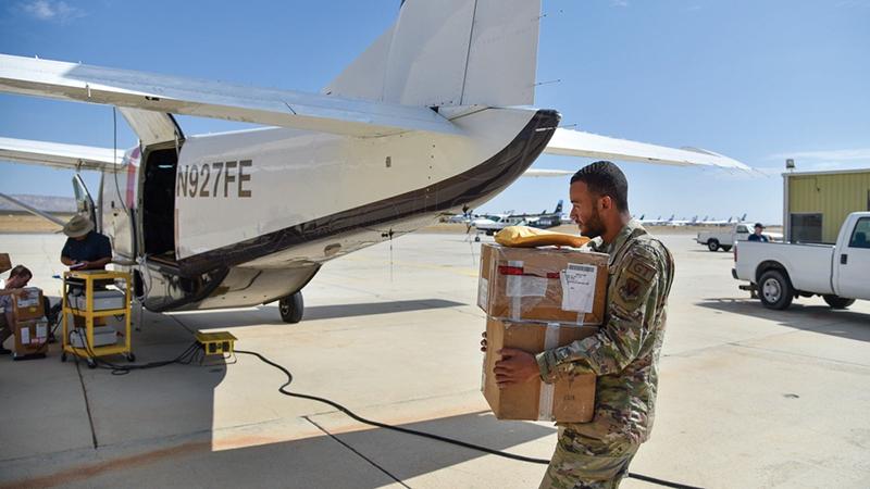 U.S. Air Force soldier carrying cargo to load uncrewed Caravans