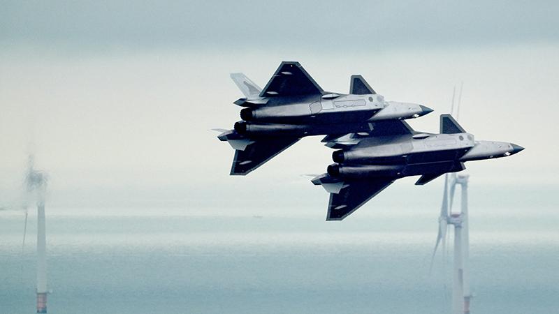 two chinese j-20 fighter aircraft banking in formation