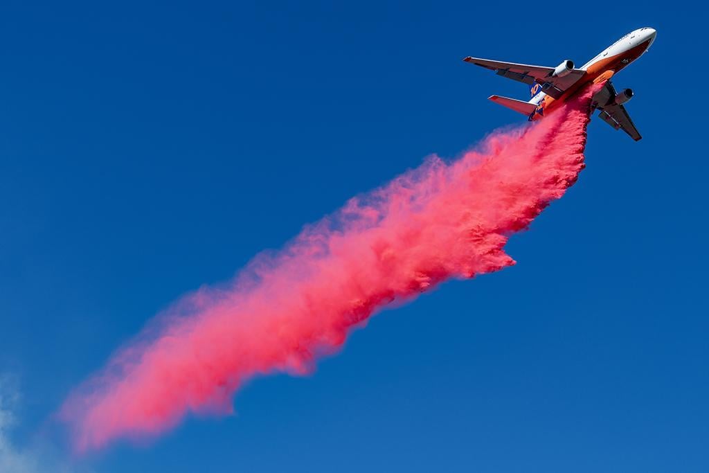 10 Tanker's DC-10 does a high-altitude drop to lay a thin layer of retardant across the Lytle Fire in Lytle Creek, California