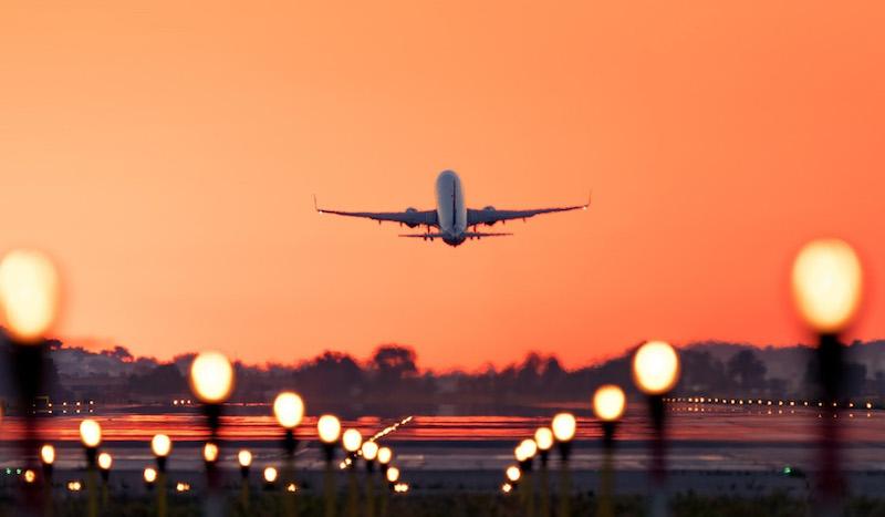 topsoe image of plane taking off at sunset