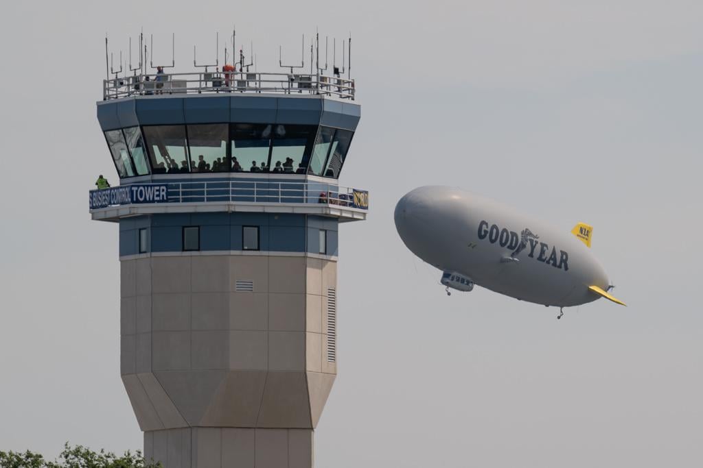 Goodyear blimp in 1925 livery and Oskosh tower