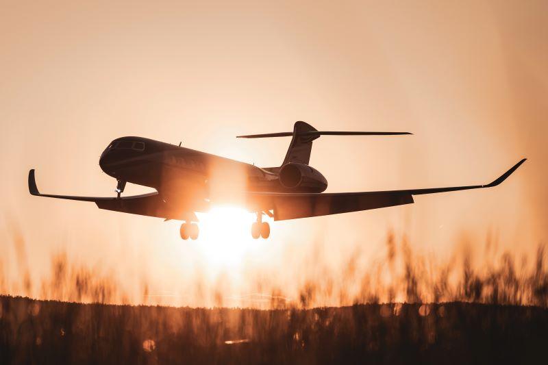 business jet in the sunset and meadows