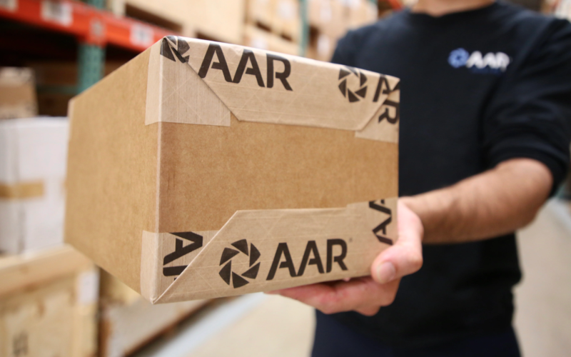 AAR employee holding a shipping box