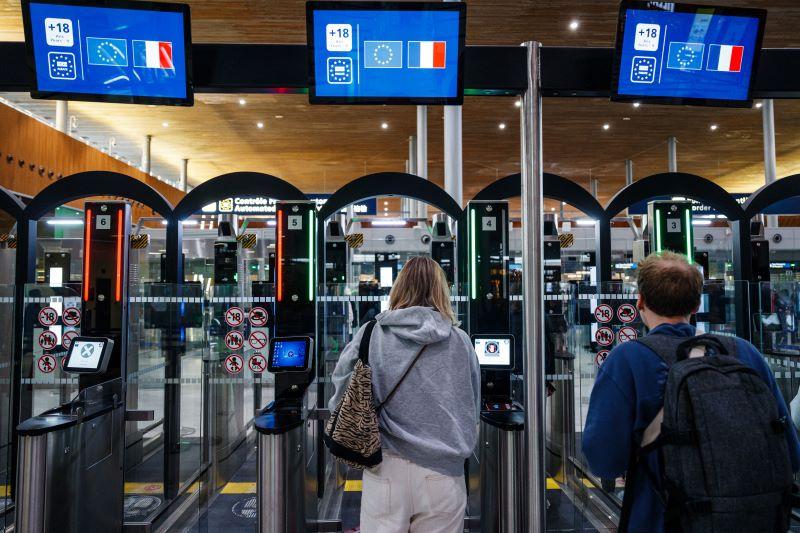 Passengers go through a facial recognition verification system at Roissy-Charles de Gaulle airport.