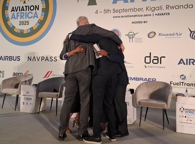 The panellists on the summit’s final panel have a group hug after a tempestuous session.